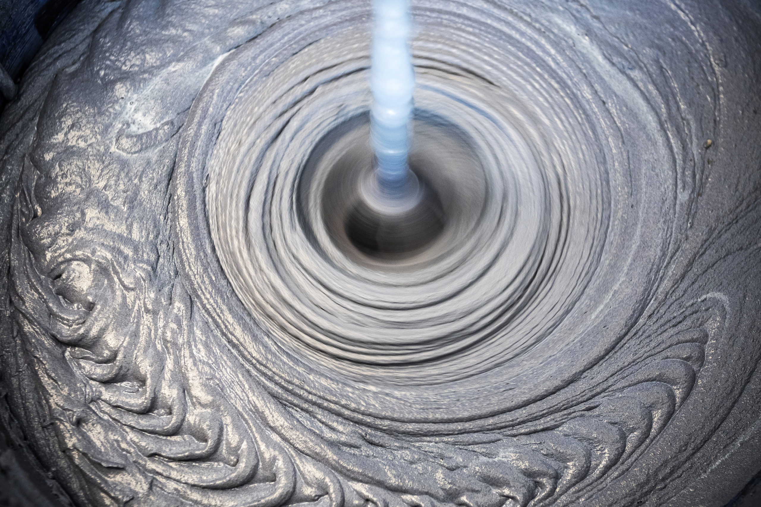 The man mixes the mortar with a perforator with a special nozzle. The process of preparing tile adhesive.